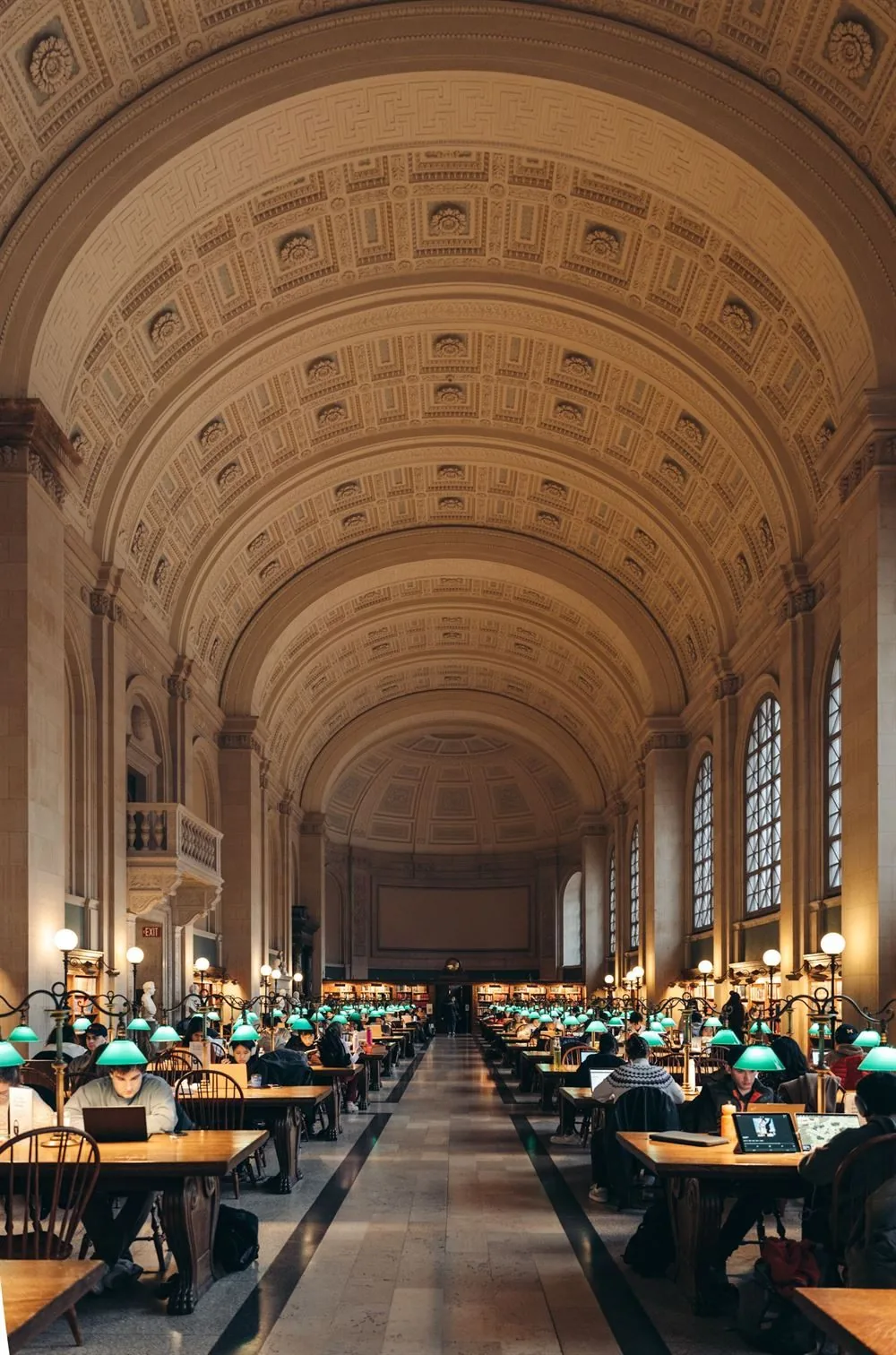 Scholars studying in a large library