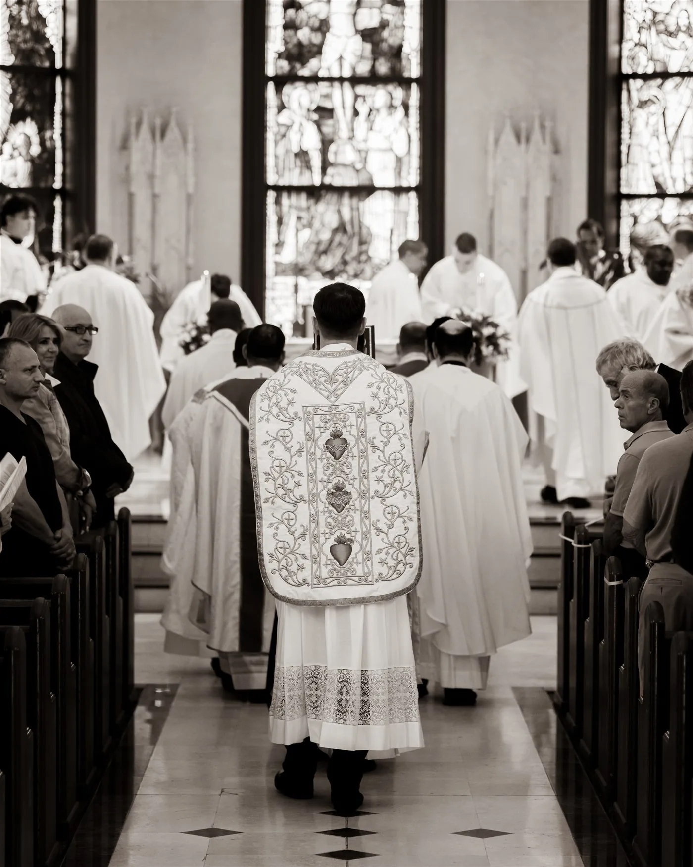 Priest walking in a liturgical procession through a church