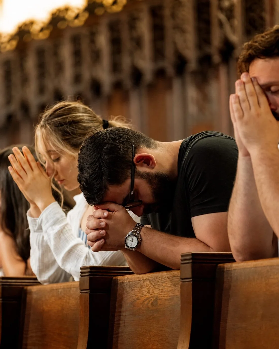 Young adults praying together in a church